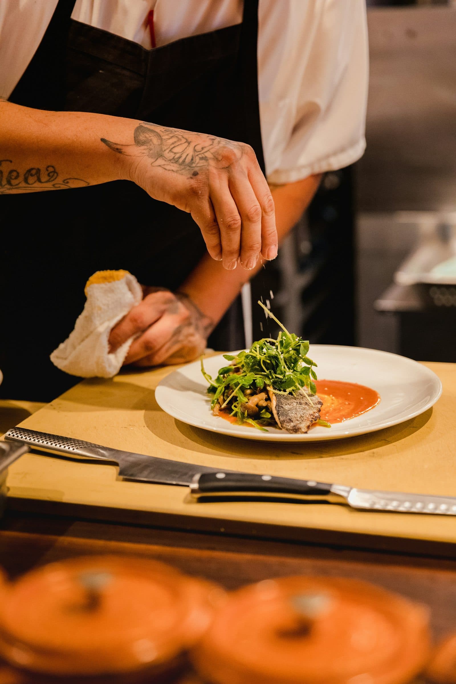 Un chef dresse une assiette en cuisine